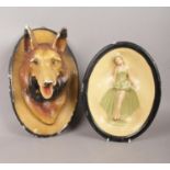 A plaster head of an Alsatian dog and oval Art Deco example of a female figure. H:32cm. Some chips.