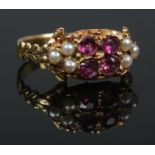 A Victorian gold, Almandine garnet and seed pearl ring. Size O. 2.63g. Tests as high carat.