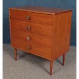 A retro teak small chest of four drawers on tapering supports.