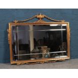 A gilt framed ornate mirror. ( 77cm height 96cm width)