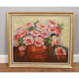 A framed oil on canvas, still life study of Roses. Signature indistinct. (58cm x 68.5cm)