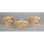 A set of three gilt metal wall lights with crystal drops. H:14cm, W:22cm.