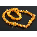 A butterscotch and toffee amber/copal freeform beaded necklace. L: 30cm.