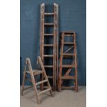 Two vintage wooden graduated step ladders & a three section pin ladder.