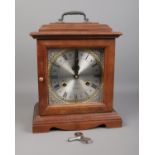 A mahogany 31 day mantle clock. Comes with key and pendulum. H:31cm W: 25.5cm. Is working but may