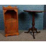 A Victorian mahogany tilt top pedestal table along with an Edwardian walnut bedside cupboard.
