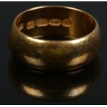 A 22ct gold wedding band. Size M, 9.24g.