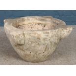 A large deep carved marble mortar, with flat base, with quarterly raised segments; Height: 31cm,