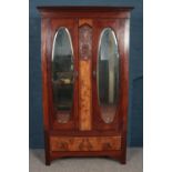 A Victorian mahogany and walnut two part bedroom suite. Comprising of mirror front wardrobe and