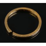 A 22ct gold band ring. Size P 1/2. Weight 3.06g. Ring has been cut.