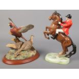 A Beswick figure of a huntsman on rearing horse along with a Border Fine Art figure titled 'Taking