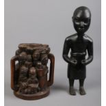 Two tribal carved pieces. To include an ebony carved male figure and a two handled multi figure