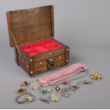 A small leather topped jewellery box, with contents of costume jewellery; including Jersey Pearl