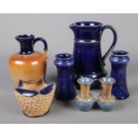A collection of Doulton stoneware. Includes pair of miniature Doulton Lambeth vases, jugs etc.