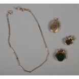 Four jewellery items. To include two swivel fobs, locket & two colour albert chain.