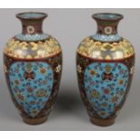 A pair of cloisonnÃ© baluster vases. Decorated with flowers. (21cm)