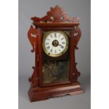 A Seth Thomas carved Mahogany Mantle Clock. With Roman numeral dial, and glazed panel door. H: 55cm,