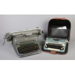 Two vintage typewriters; a cased Imperial 'Good Companion' and Olympia De Luxe 7.6. Some scuffs to