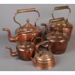 Five Victorian copper kettles. Including three graduated examples, etc.