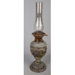 An ornate cast metal oil lamp. Decorated with figures. (56cm)