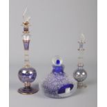 Three glass perfume bottles. To include two possibly Egyptian bottles with leaf stoppers. Tallest: