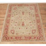 An ivory ground Ralph Lauren rug with red border. (120cm x 170cm) Would require a clean. Minor tears