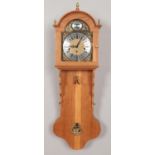 A 20th century oak cased Vienna style wall clock inscribed Tempus Fugit. (87cm length) with weights