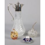 A silver mounted scent atomizer, silver rimmed miniature porcelain cup & saucer, oriental scent