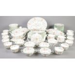 A box of Minton Haddon Hall dinnerwares. Including cup & saucers, teapot, sugar bowls, etc.