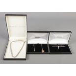 Four silver necklaces, to include one Ernest Jones example set with paste stones, in original box.