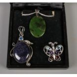 Three silver pendants, to include diamond, garnet and amethyst set butterfly example, and jade