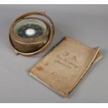 A nautical brass gimbal/compass along with an 1876 ships log book for Ship Salisbury.