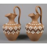 A pair of Doulton Lambeth Silicon ware ewers. Both stamped 5475 to base. 21cm.