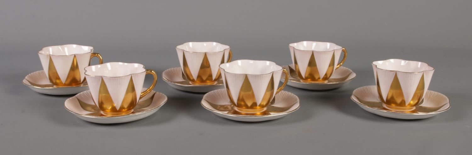 A Shelley 'Danity' part tea set. Comprising of six cups and saucers in pink and gold. One cup with