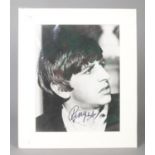 Beatles interest; a signed mounted photograph of Ringo Starr. Height: 31cm, Width: 26cm. No