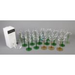 An assortment of coloured stem hock glasses. To include green and amber coloured stems along with