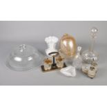 A box of assorted glassware. To include a glass cake stand and cover, decanter and vase etc.