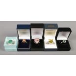 Five silver dress rings, set with large polished stones, all in boxes. Various sizes (Mx2, Nx2, O).