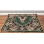 A green ground wool rug with central medallion design.(120cm x 170cm)