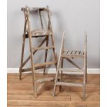 Two vintage wooden graduated step ladders.