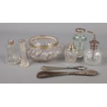A collection of silver mounted items. Includes atomiser, glass bowl, shoe horns etc.