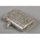 A small silver vesta case with scrolled decoration. Assayed for Birmingham, 1910 by Constantine &