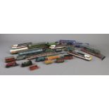 A collection of die-cast and plastic railway items including trains, carriages/wagons.