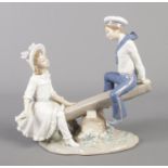 A Lladro figure group modelled as a girl and sailor on a see-saw. Good condition.