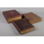 A large Victorian family bible, together with two Victorian leather photo albums.