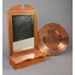 A carved hall way mirror with with pull up compartment and copper coloured stamped charger plate.