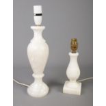 Two Alabaster desk lamps. Tallest: 39cm. Untested. Crack to top of smallest lamp.