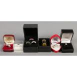 A collection of eight box silver dress rings, including large polished stone and gem set examples.