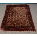 A rectangular red ground rug, with geometric design. 190cm x 130cm.