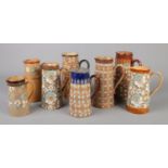 Eight Doulton Slaters Patent jugs. Mainly Doulton Lambeth, one Royal Doulton example. Tallest